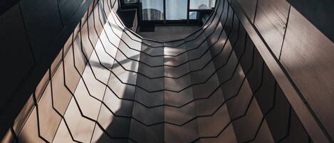 A modern architectural design with a curved, metallic surface.