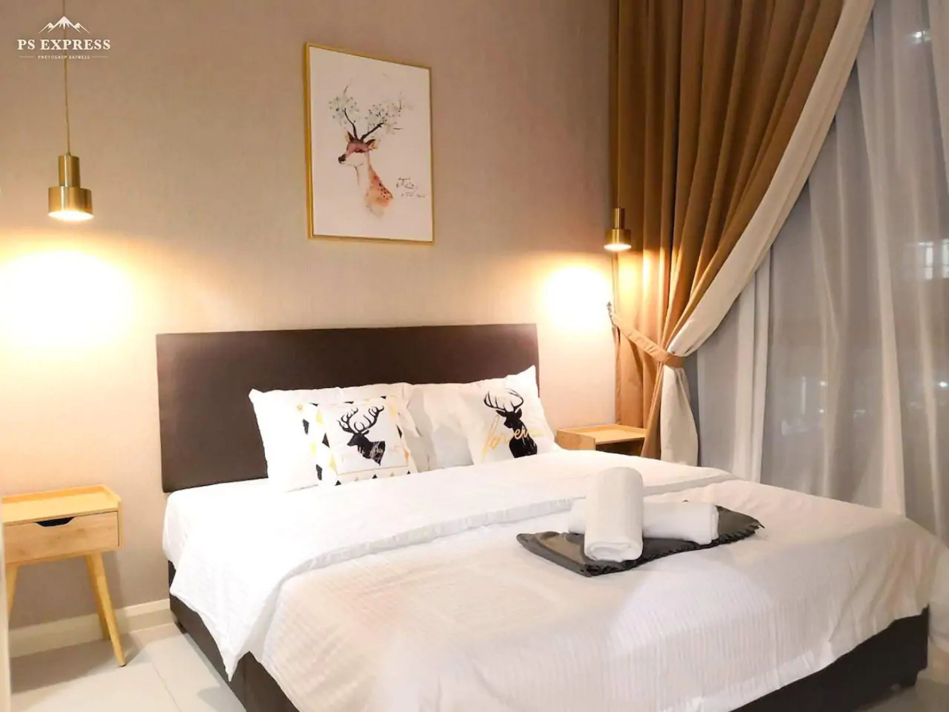 A hotel room with a large bed, two bedside tables, a headboard, a wall-mounted picture, and a window with curtains.