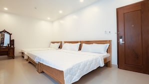Un dormitorio con una cama grande, un armario de madera y un espejo.