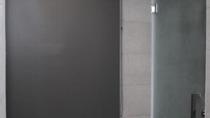A modern bathroom with a glass shower enclosure, a dark-colored shower curtain, and a recessed ceiling light. - Rest and Comfort Boutique Hotel (Kuala Terengganu)