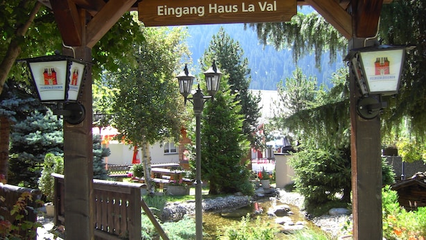 A wooden pergola with a sign reading "Eingang Haus La Val". - B&B Garni Casa La Val (Tujetsch)