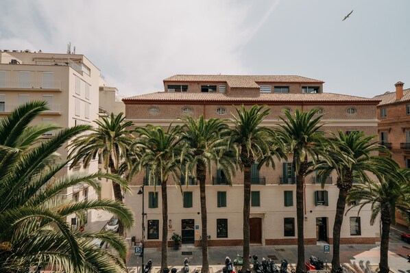 Stunning multi-story building with a classic design, surrounded by lush palm trees.