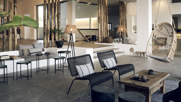 A modern lounge area with wicker furniture, a hanging chair, and a coffee table. - Skiathos Blu (Skiathos)