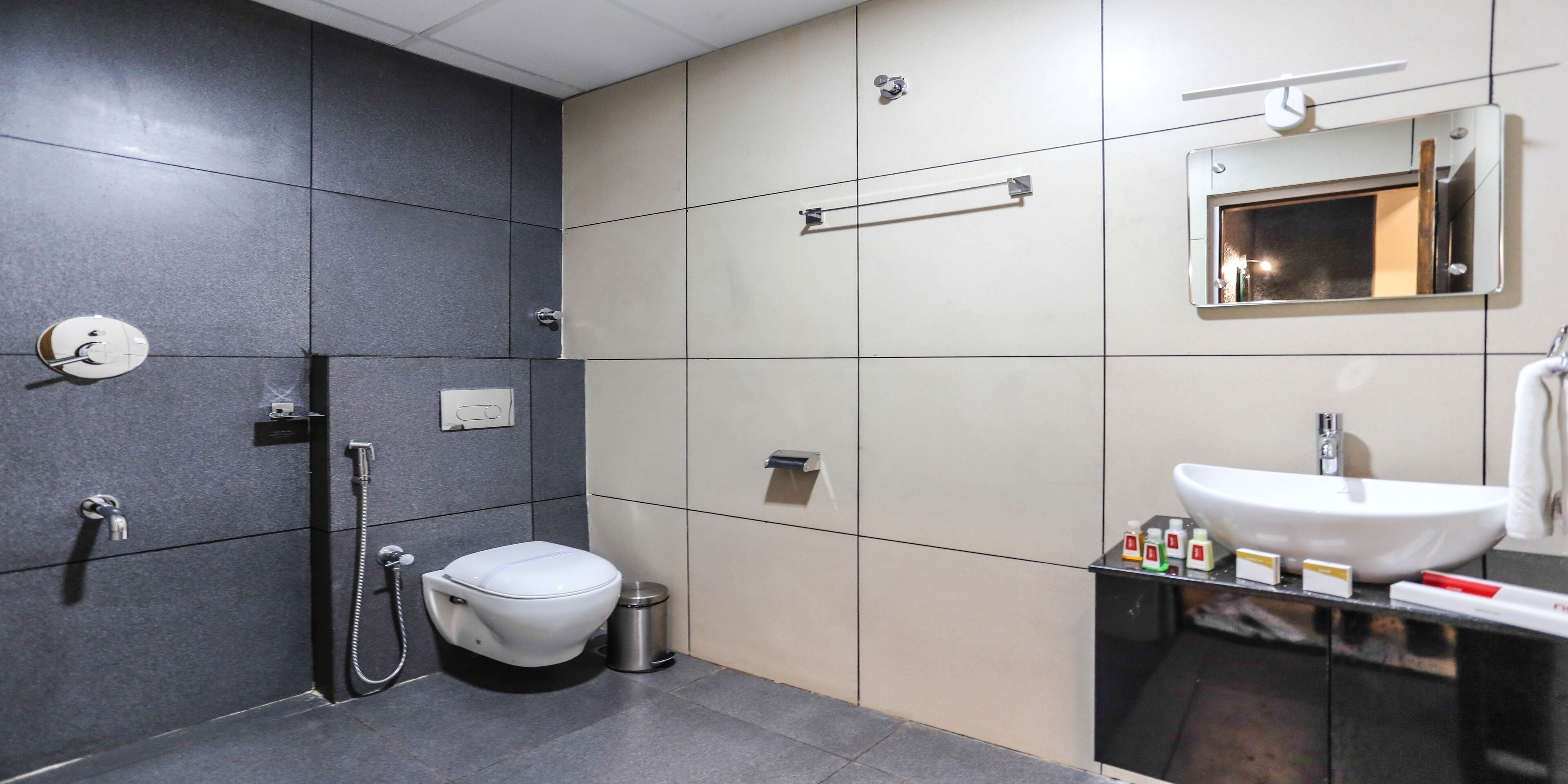 A modern bathroom with a toilet, bidet, and sink.