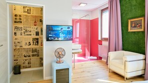 A modern living room with a vintage-style TV, a small fan, and a white sofa. - Leuhusen Center Apartments Vienna (Vienna)