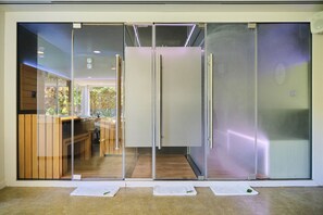 A modern interior with a sliding glass door leading to a kitchen area.
