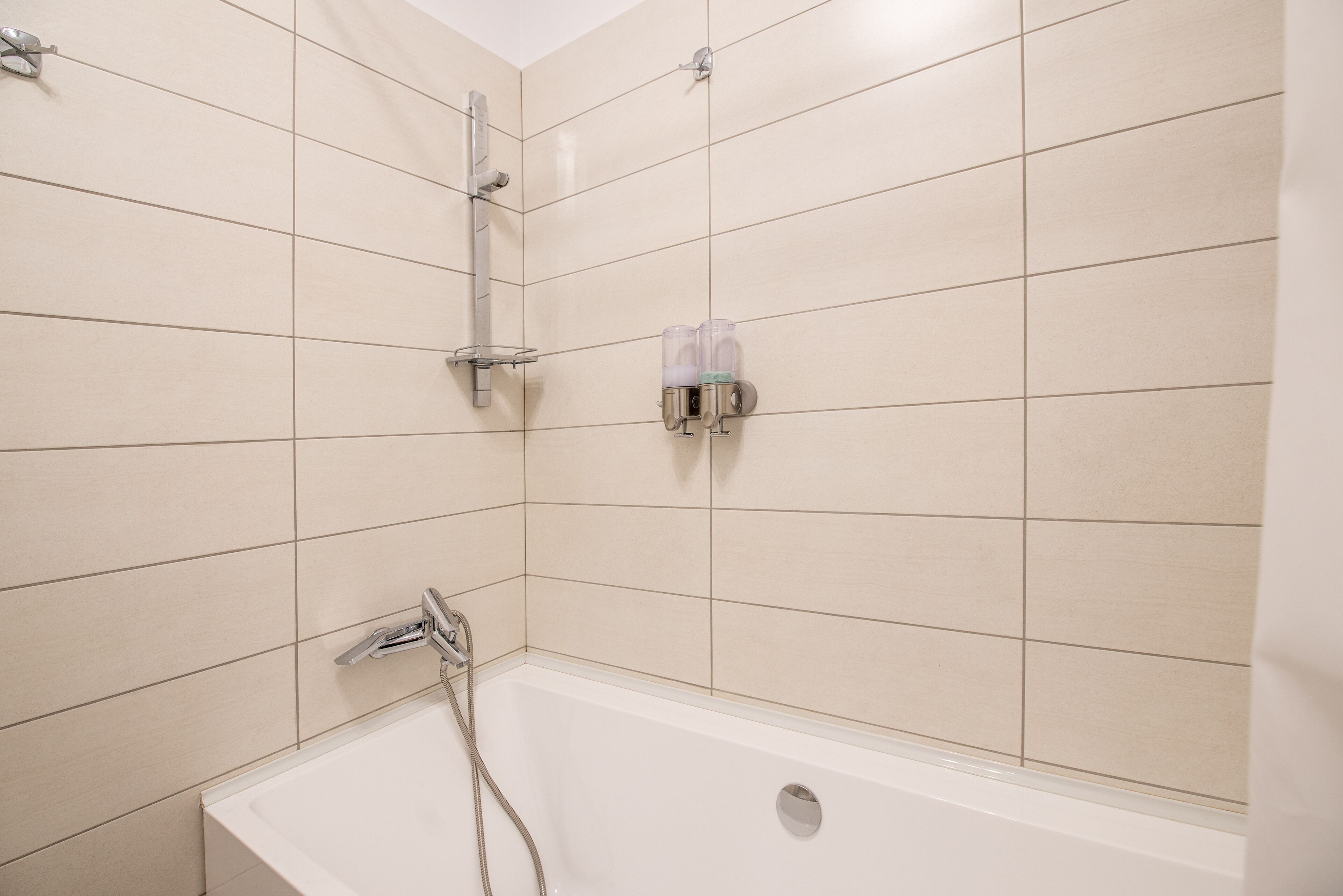 A bathroom with a bathtub, a shower, and a toilet.