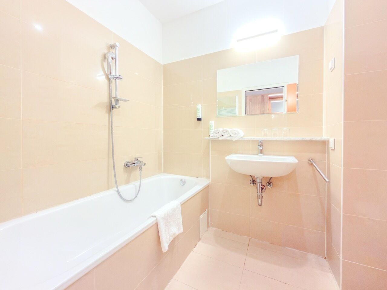 A bathroom with a bathtub, a sink, and a shower.