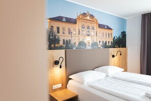 Een bureau, geluiddichte muren, gratis wifi, beddengoed