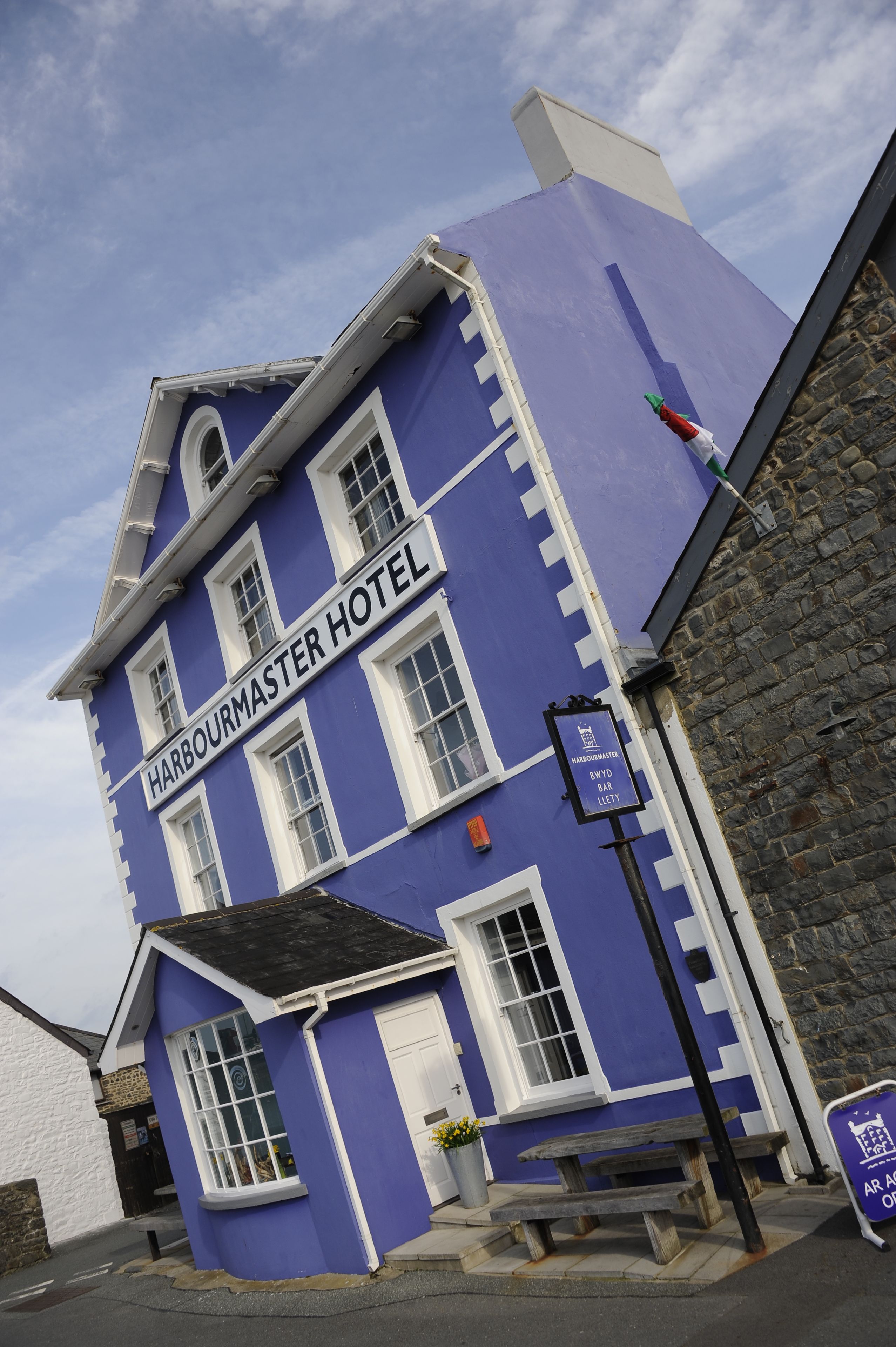 A two-story building with a sign reading "Harbourmaster Hotel".