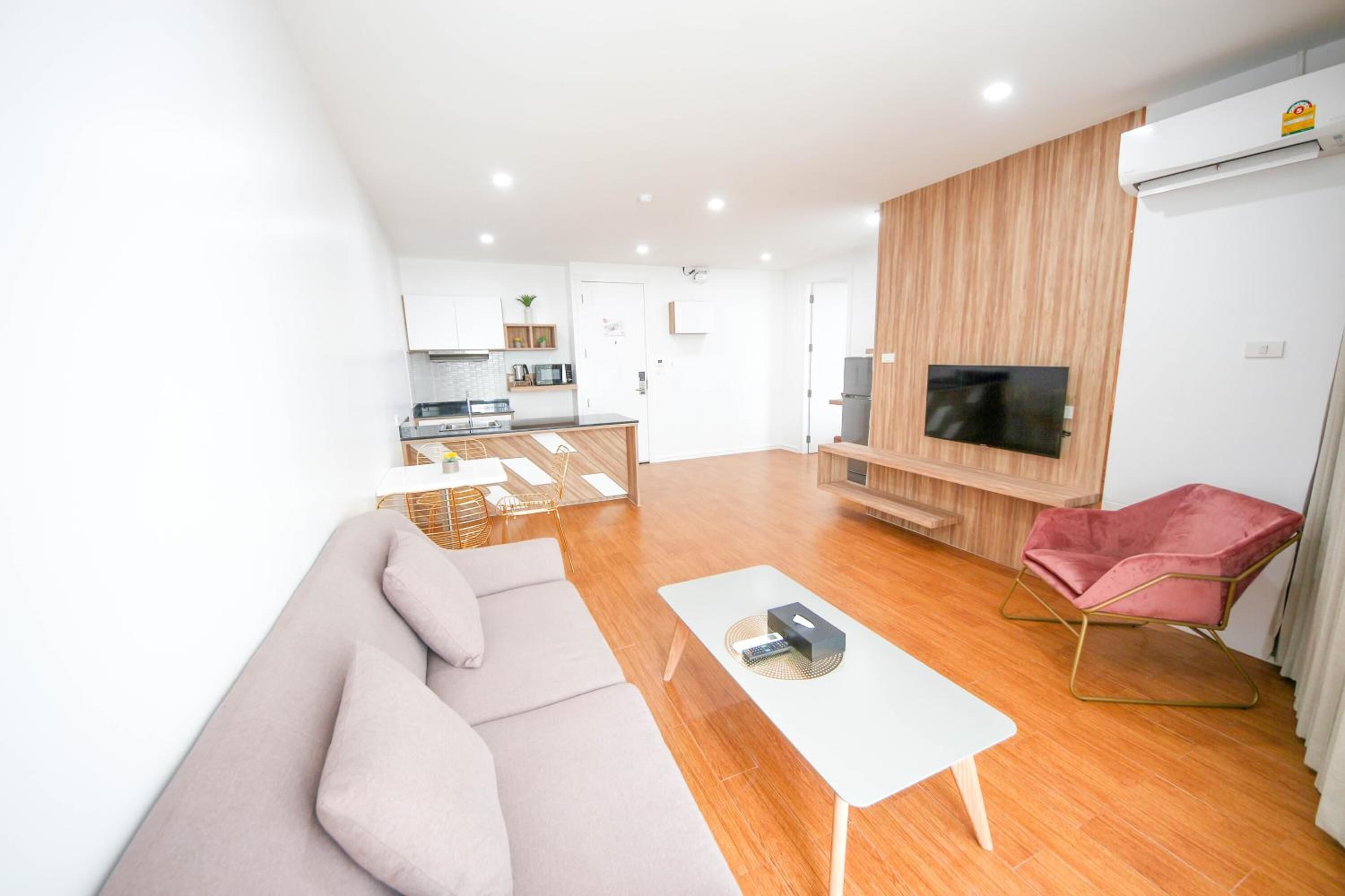 A modern living room with a sofa, a coffee table, and a TV wall unit.