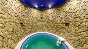 A stone-walled indoor pool with a blue interior. - Laguna Hotel (Slavske)