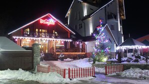 A hotel with a lit sign reading "Hotel". - Laguna Hotel (Slavske)