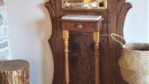 A wooden vanity with a mirror, a sink, and a small drawer. - Victoria's Country Apartments (Zagora-Mouresi)