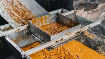 A metal trough with a liquid substance being poured into it.