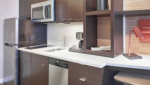 A modern kitchen with stainless steel appliances, a dishwasher, and wooden cabinetry. - TownePlace Suites by Marriott Medicine Hat (Medicine Hat)