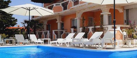 Seasonal outdoor pool, open 9:00 AM to 9:00 PM, pool umbrellas