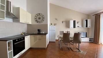 Standard Apartment, Partial Sea View | Private kitchen | Full-sized fridge, stovetop, coffee/tea maker, toaster