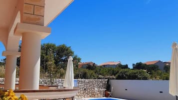 Seasonal outdoor pool, open 9:00 AM to 9:00 PM, pool umbrellas