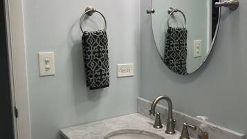 Shower, hair dryer, towels, toilet paper