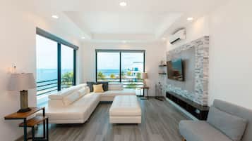 Deluxe Penthouse, 2 Bedrooms, Pool Access, Ocean View (Sea Front) | Living area | Flat-screen TV