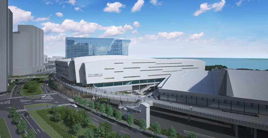 A modern building with a unique architectural design, featuring a large glass facade and a curved roof structure.