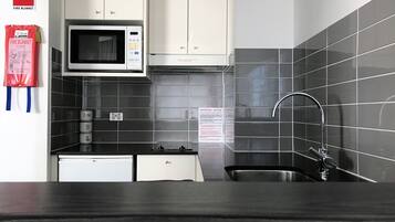 Mini-fridge, microwave, electric kettle, cookware/dishes/utensils