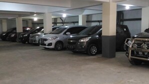 A multi-level parking garage with several cars parked. - K15 Exclusive (Malang)