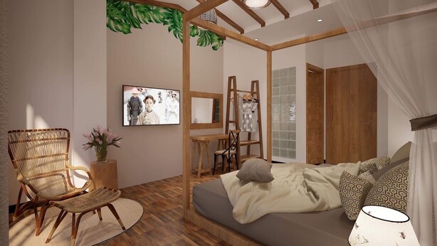 A modern bedroom with a bed, a chair, a small table, and a TV. - Banana Flower Homestay (Da Nang)