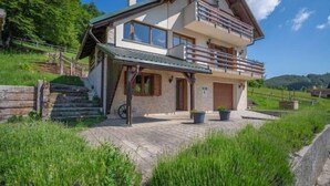A two-story house with a balcony, a stone staircase, and a paved driveway. - Lady Lavender by Interhome (Mrkopalj)