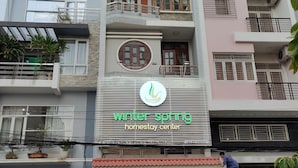 A multi-story building with a sign for 'Winter Spring Homestay Center'. - Winter Spring Homestay Center (Can Tho)
