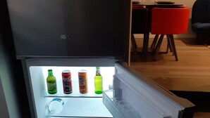 Ein offener Kühlschrank mit Getränken und einer Dose.