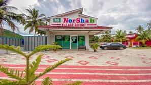 NorShah Village Resort with a welcoming entrance, palm trees, and a patterned floor. - Norshah Village Resort (Langkawi)