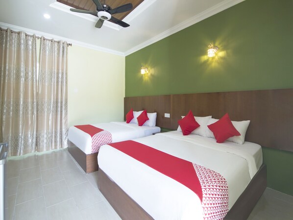 A hotel room with two beds, a ceiling fan, and two wall-mounted lights. - Norshah Village Resort (Langkawi)