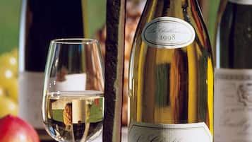 A bottle of La Chablisienne wine from 1998 and a wine glass.