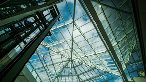 A modern glass ceiling structure with a geometric design, allowing natural light to enter a building. - Mercure Geneva Airport  (Meyrin)