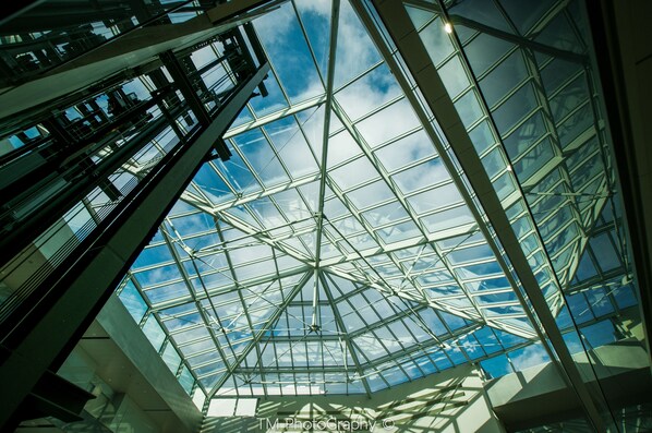 A modern glass ceiling structure with a geometric design, allowing natural light to enter a building. - Mercure Geneva Airport  (Meyrin)