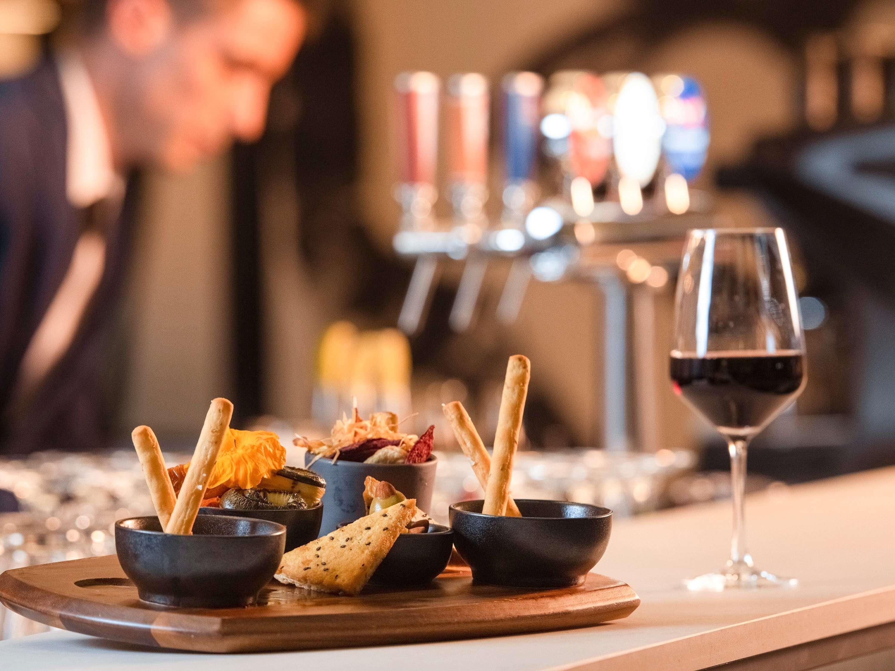 A dining table with a variety of dishes and a wine glass.