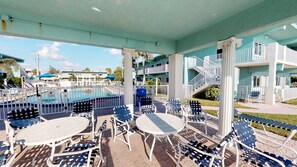 Relax by the pool surrounded by comfortable seating and a view of the surrounding buildings.
