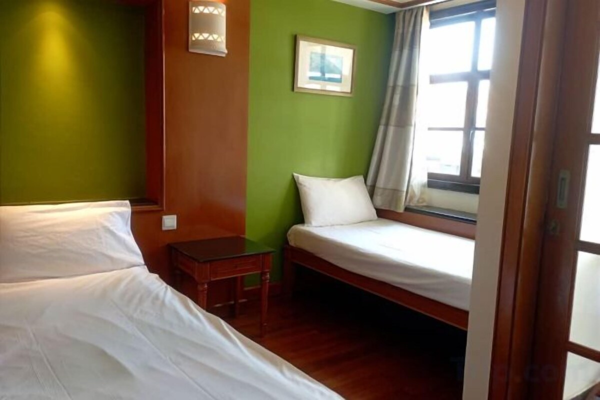 Desk, iron/ironing board, bed sheets