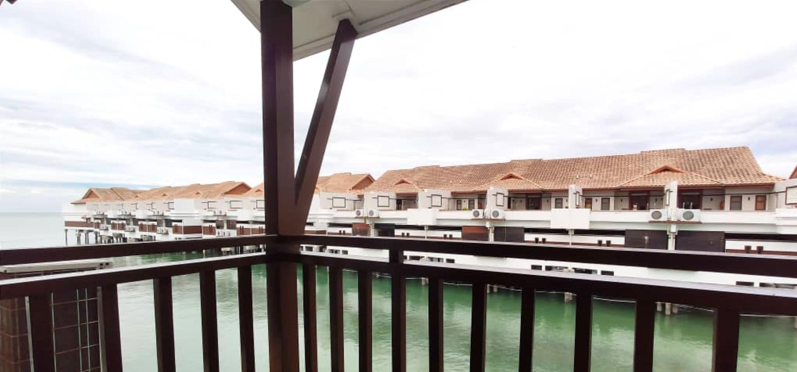 A series of overwater bungalows with a view of the ocean.