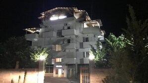 A multi-story building with a modern architectural design, featuring balconies and a central entrance. - Hotel Relax Dhermi (Himarë)