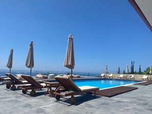 Seasonal outdoor pool, open 7:30 AM to 11:30 PM, pool loungers