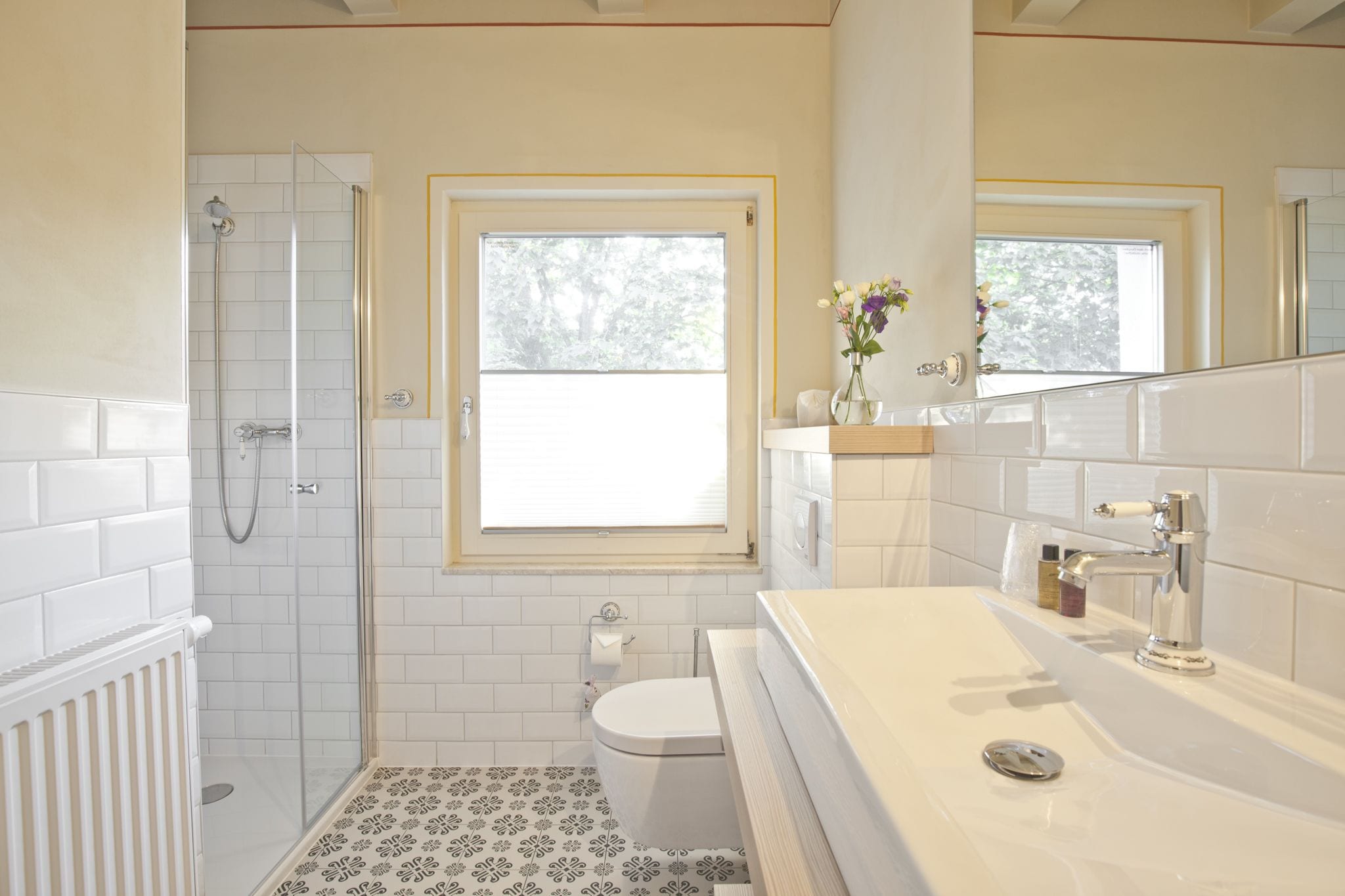 A bathroom with a shower, toilet, and sink.