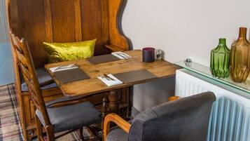 A dining area with a wooden table, chairs, and a bench.