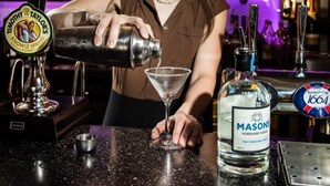 A bartender pouring a drink into a martini glass. - The Sawley Arms (Ripon)