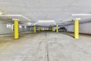 A parking garage with concrete floors and yellow pillars. - Giant Steps 17 - 2 bdrm 2 bath ski in/out in building one - Next to the slopes (Brian Head)