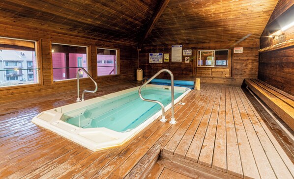 A wooden interior with a hot tub, wooden flooring, and windows. - Giant Steps 17 - 2 bdrm 2 bath ski in/out in building one - Next to the slopes (Brian Head)