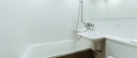 A modern bathroom with a bathtub, a sink, and a mirror.