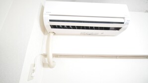 A white air conditioning unit mounted on a wall. - GATE80 nagai stadium (Osaka)
